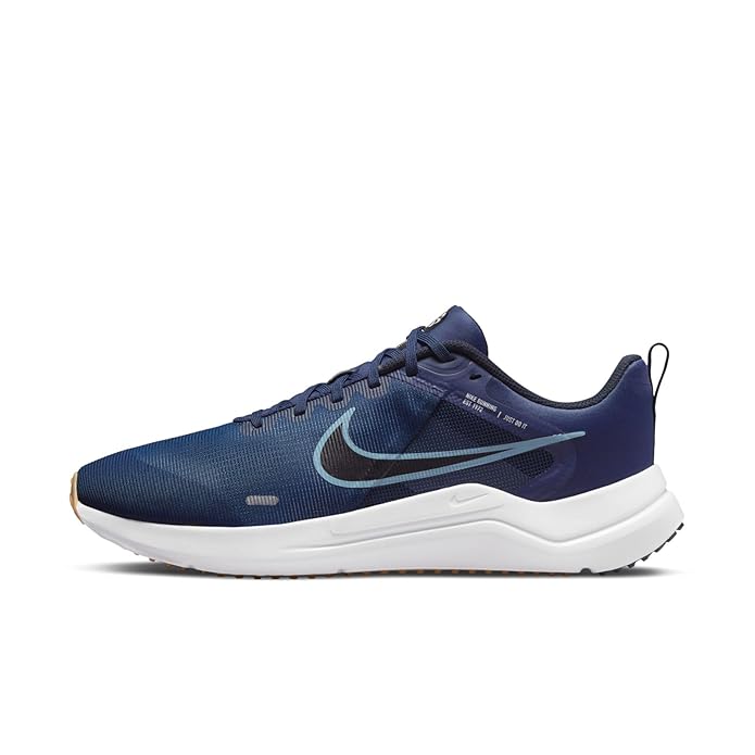 The image shows a pair of men’s Nike running shoes, emphasizing their sleek, lightweight design and supportive sole.