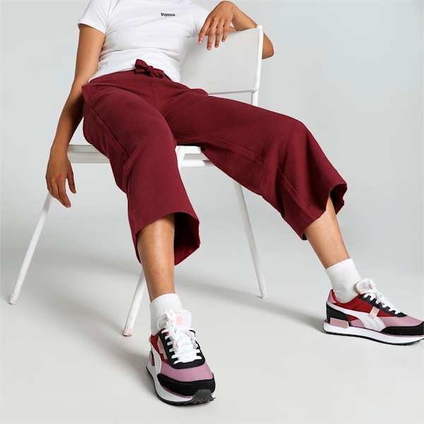 Side view of PUMA Women's Lower, highlighting the relaxed fit, soft fabric, and signature PUMA logo, perfect for casual wear and lifestyle activities.