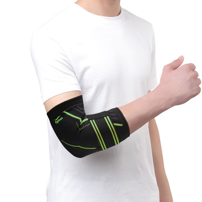 The image shows the Tynor Elbow Support Air Pro from a side angle, highlighting its breathable material, adjustable straps, and ergonomic fit that provide optimal support and comfort for elbow stability