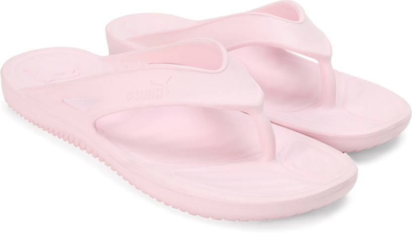 A top-down view of PUMA slippers for women, highlighting their soft, cushioned sole and sleek design. The slippers are displayed with the PUMA logo visible, placed on a clean, neutral background to emphasize their comfort and style.