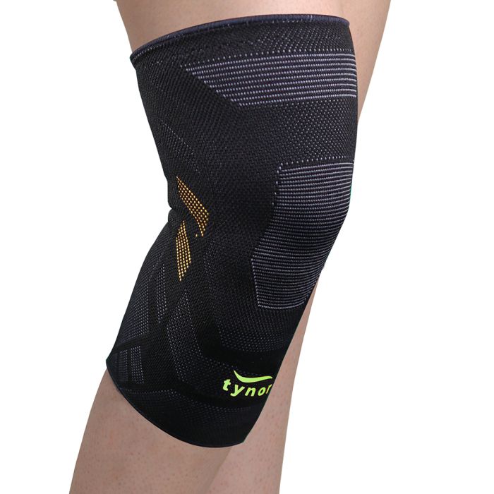 The image shows the Tynor Knee Cap Air Pro from a side angle, highlighting the breathable fabric, adjustable straps, and ergonomic design for enhanced knee support and comfort