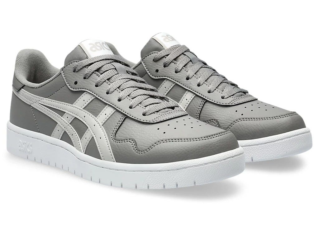 The photo showcases a close-up view of the Asics Men’s Lace-Up Lifestyle Shoe, taken from the side angle, highlighting the sleek design, breathable fabric, and cushioned sole. The shoes are placed on a neutral background, emphasizing their modern appeal