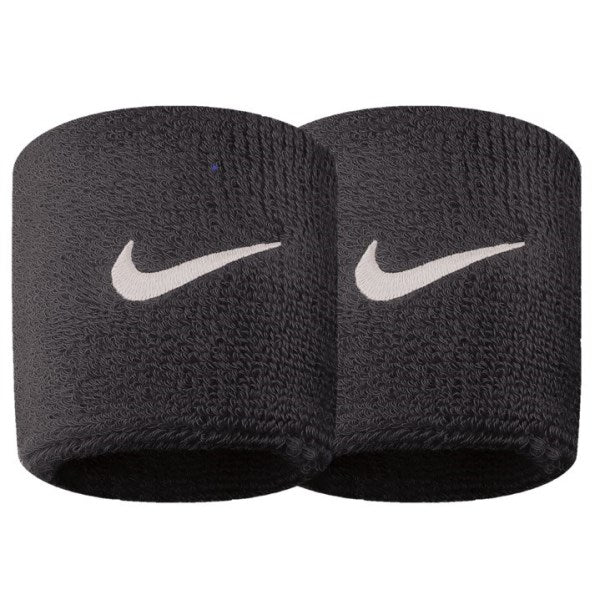 The image shows a Nike unisex wristband wrapped around the wrist, highlighting its soft, absorbent material and snug fit.