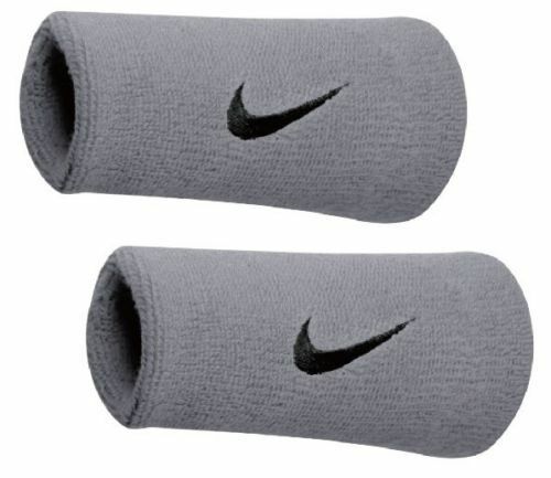 The image shows a Nike unisex wristband wrapped around the wrist, highlighting its soft, absorbent material and snug fit.