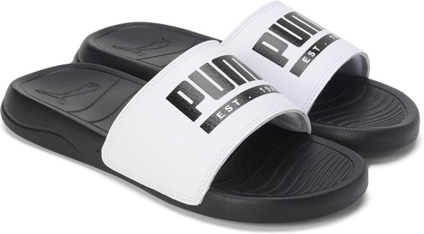 Side view of PUMA Men's Slippers, showcasing the soft plush interior, non-slip outsole, and iconic PUMA logo, designed for comfort and stability during indoor wear.