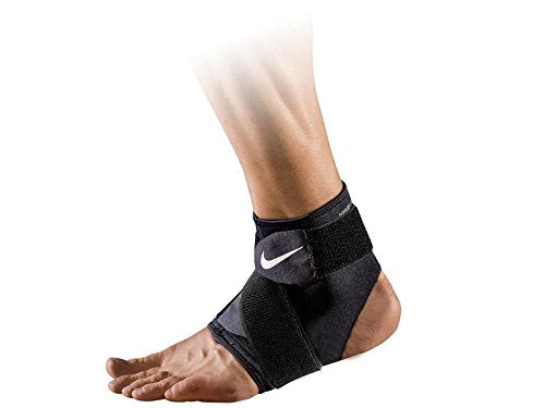 The image shows a Nike ankle wrap fitted snugly around an ankle, showcasing its supportive and adjustable design.