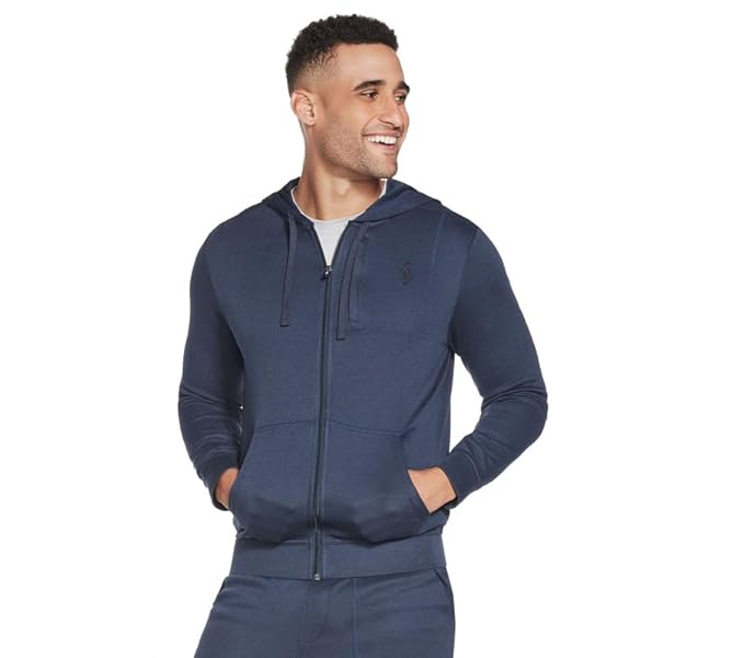 A detailed view of the Skechers GoKnit Pique Full-Zip Jacket, highlighting its textured fabric and streamlined silhouette in a sporty setting