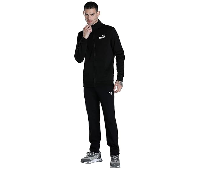 Front view of the PUMA Zippered Jersey Sweatpants in Black, featuring zippered pockets, tapered legs, and an elastic waistband with a drawstring for a perfect fit.