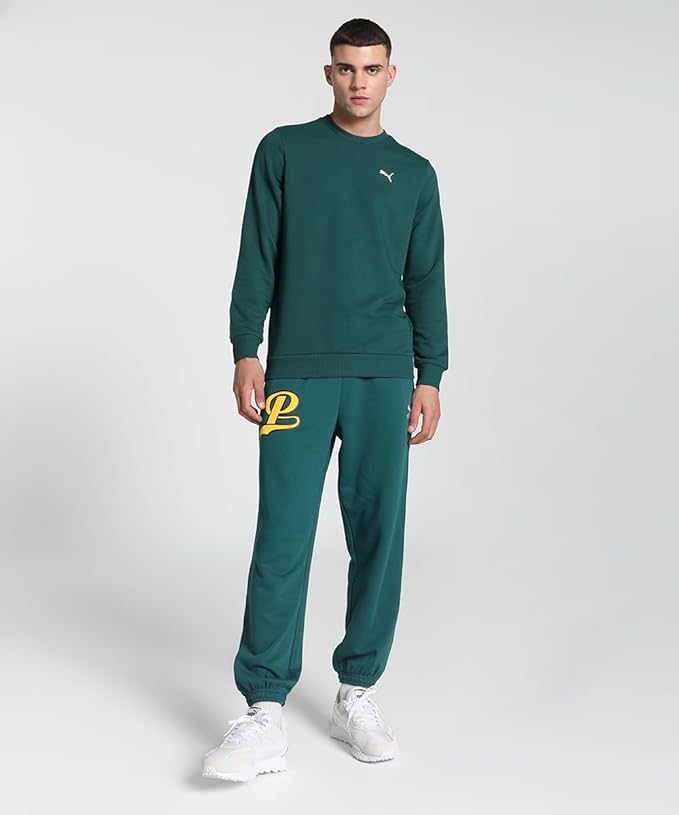 Front view of the PUMA Crew TR in Calming Green, featuring a relaxed fit, soft fabric, and a sleek design with the iconic logo.