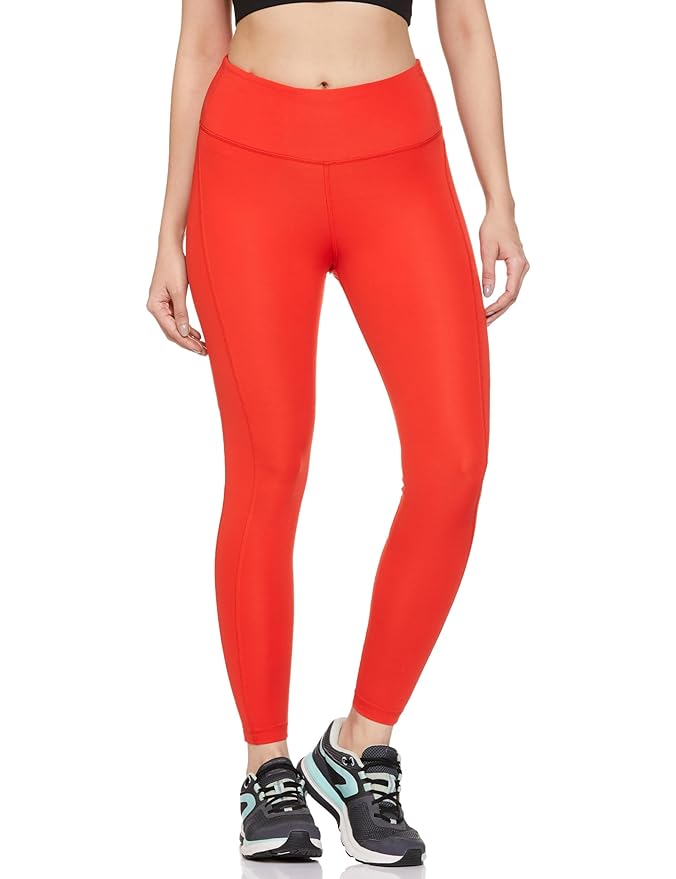 Side view of the NIKE AS W NK DF Fast Tight in red, highlighting the stretchy, form-fitting design and high-rise waistband for a flattering, secure fit.