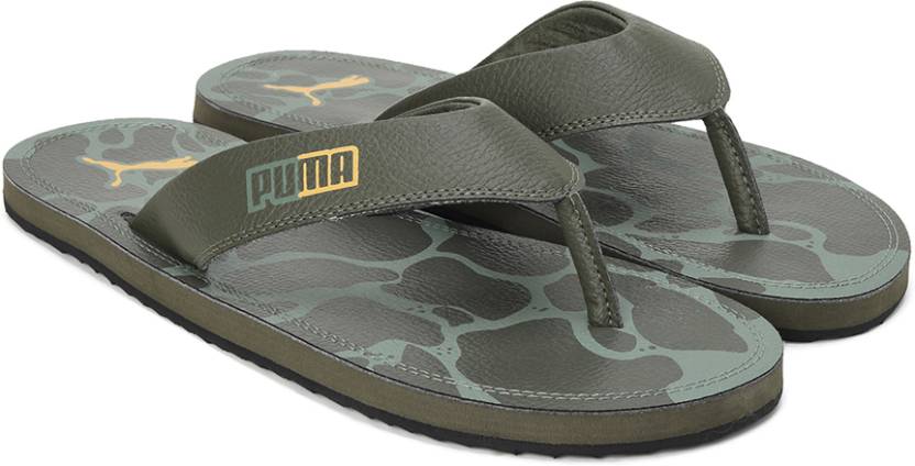 Side view of PUMA Men's Slippers, showcasing the soft plush interior, non-slip outsole, and iconic PUMA logo, designed for comfort and stability during indoor wear.