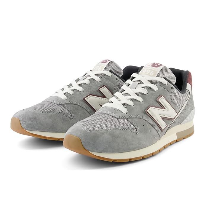 A side-angle view of New Balance men's lifestyle shoes showcasing the retro basketball-inspired design durable leather upper lace-up closure and premium craftsmanship placed on a clean background to highlight their unique features.