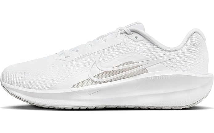 A dynamic side-angle view of Nike men’s lace-up running shoes highlighting the streamlined design, cushioned midsole, and bold Nike swoosh, set against a clean, sporty background