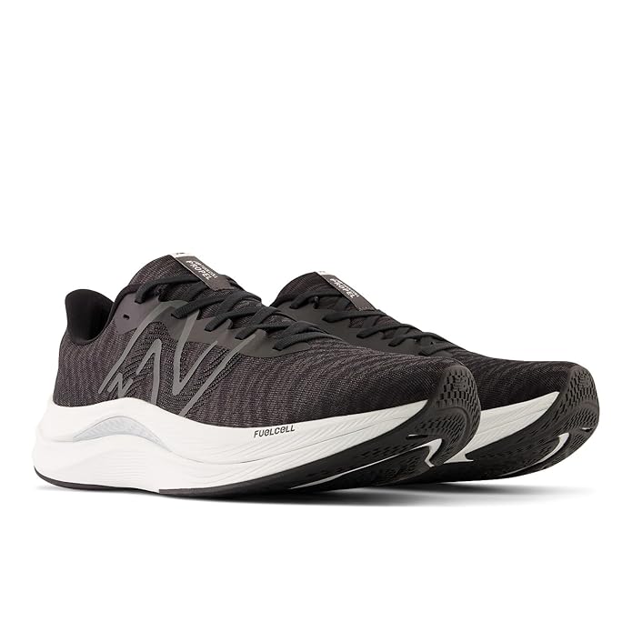 A side-angle view of New Balance men's running shoes highlighting the breathable mesh upper lace-up design and cushioned midsole placed on a clean background to emphasize their lightweight and athletic features.