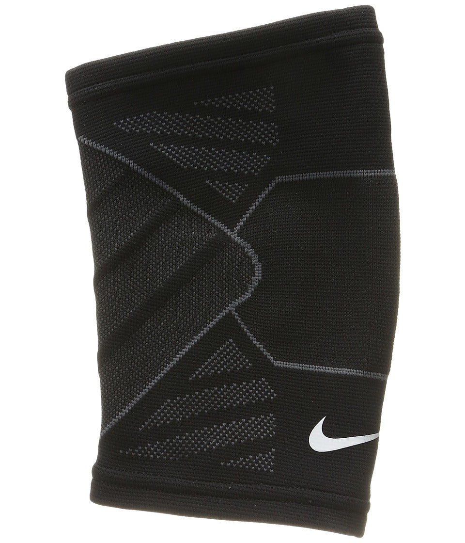 The image shows a unisex Nike elbow sleeve snugly fitted on the arm, emphasizing its supportive and flexible design.