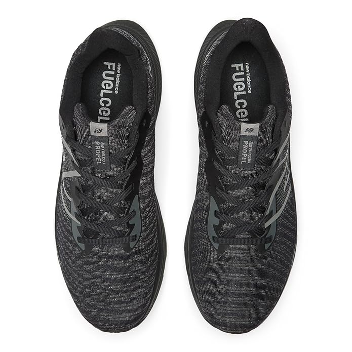 A side-angle view of New Balance men's running shoes highlighting the breathable mesh upper lace-up design and cushioned midsole placed on a clean background to emphasize their lightweight and athletic features.