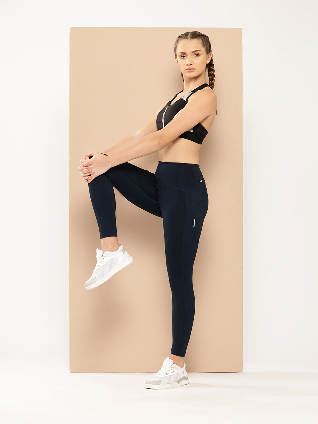 A front view of Alcis Women’s Round the Clock Tights highlighting the sleek, form-fitting design and premium fabric, displayed on a clean, minimalistic background