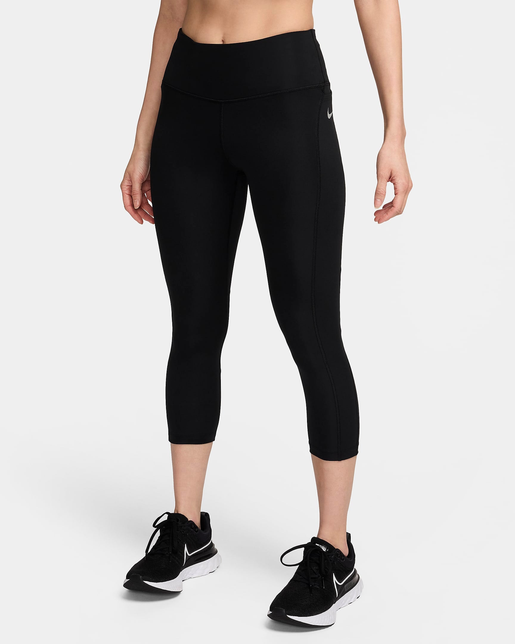 Side view of the NIKE AS W NK DF Fast Crop in black, showcasing the sleek, cropped design and stretchy fabric for maximum flexibility and comfort during workouts.