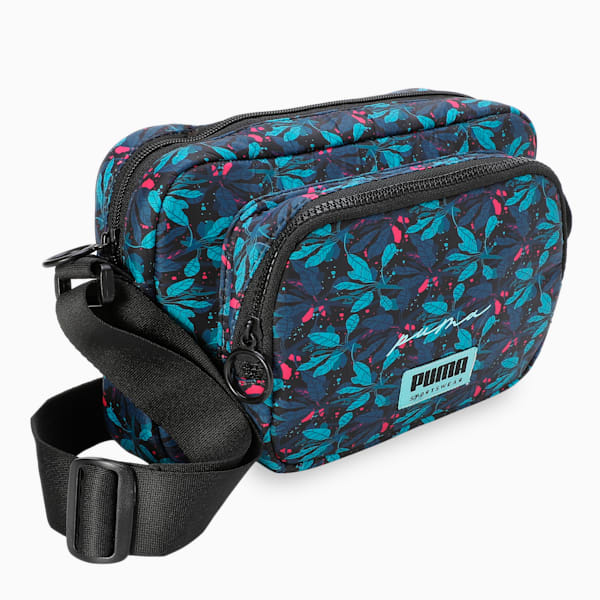 Side view of PUMA Women's Lifestyle Duffle Bag, showcasing the spacious compartments, adjustable shoulder strap, sturdy handles, and iconic PUMA logo, designed for both style and practicality.