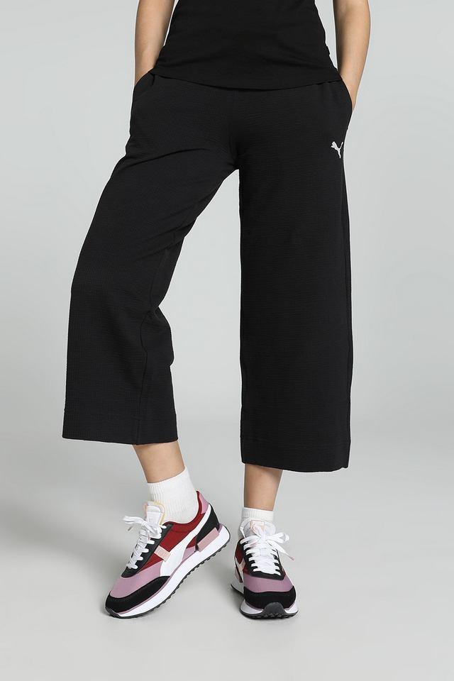 Side view of PUMA Women's Lower, highlighting the relaxed fit, soft fabric, and signature PUMA logo, perfect for casual wear and lifestyle activities.