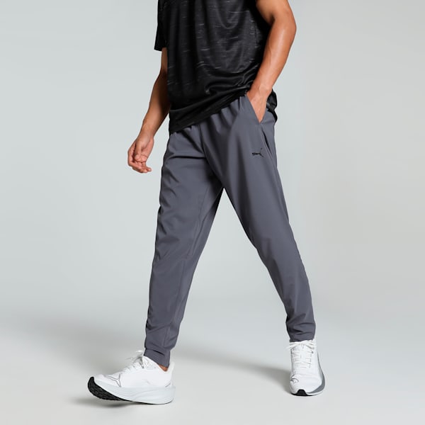 A pair of men’s tapered pants made with lightweight woven fabric, featuring an elastic waistband and a modern, sleek design