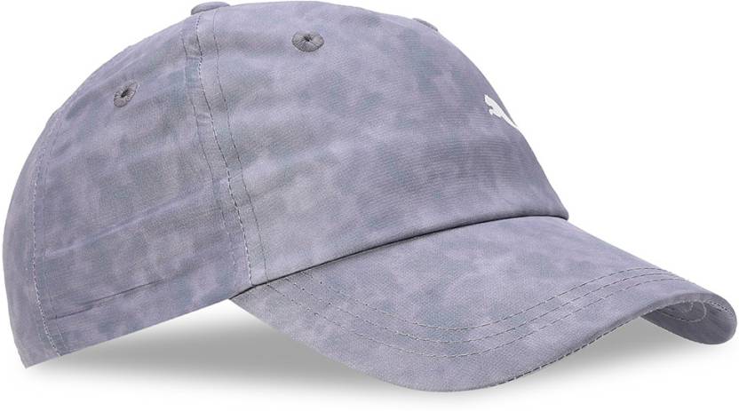 Side view of the PUMA Washed Cap showcasing its vintage washed fabric, adjustable strap, and the iconic logo, displayed against a neutral background.