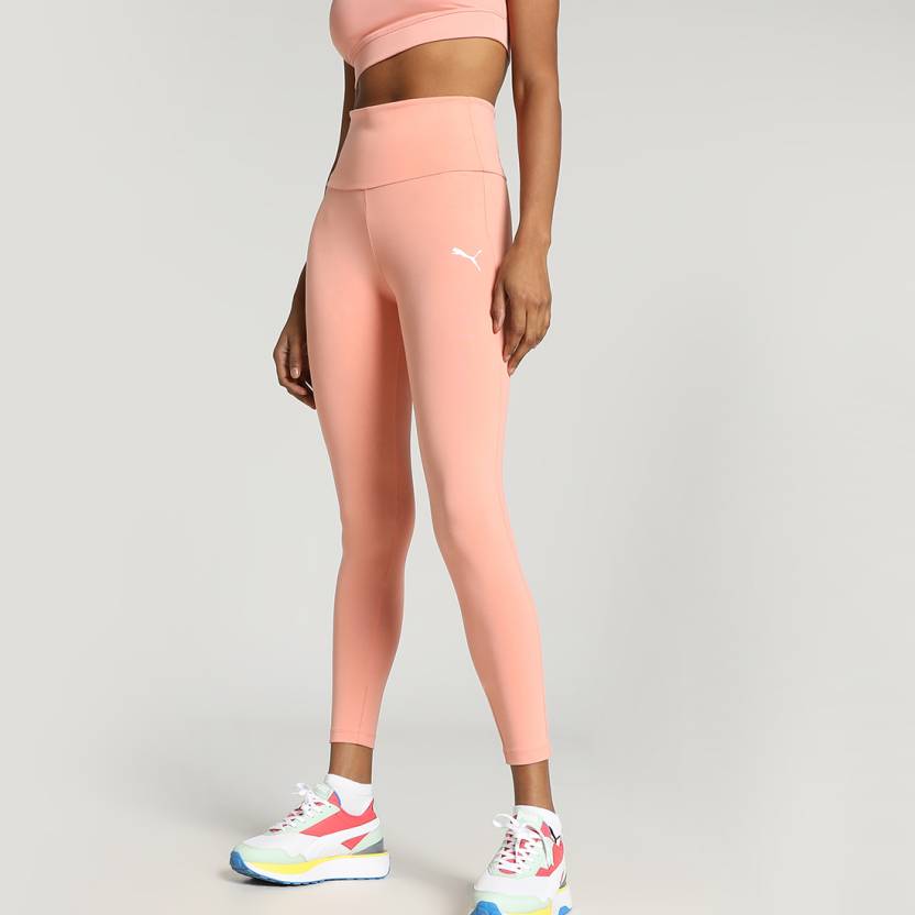 Side view of PUMA Women's Tights, showcasing the snug fit, stretchy fabric, and iconic PUMA logo, designed for a stylish and comfortable lifestyle look.