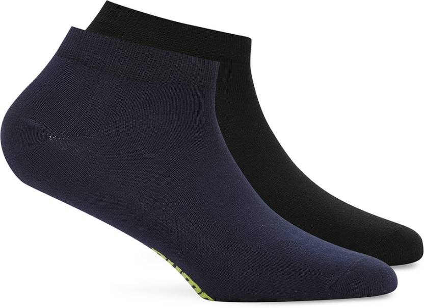 A flat lay image of PUMA PO2 socks arranged to highlight their texture and PUMA logo. The socks are shown from a slight angle to emphasize their fit and quality, with a clean background to enhance their design.