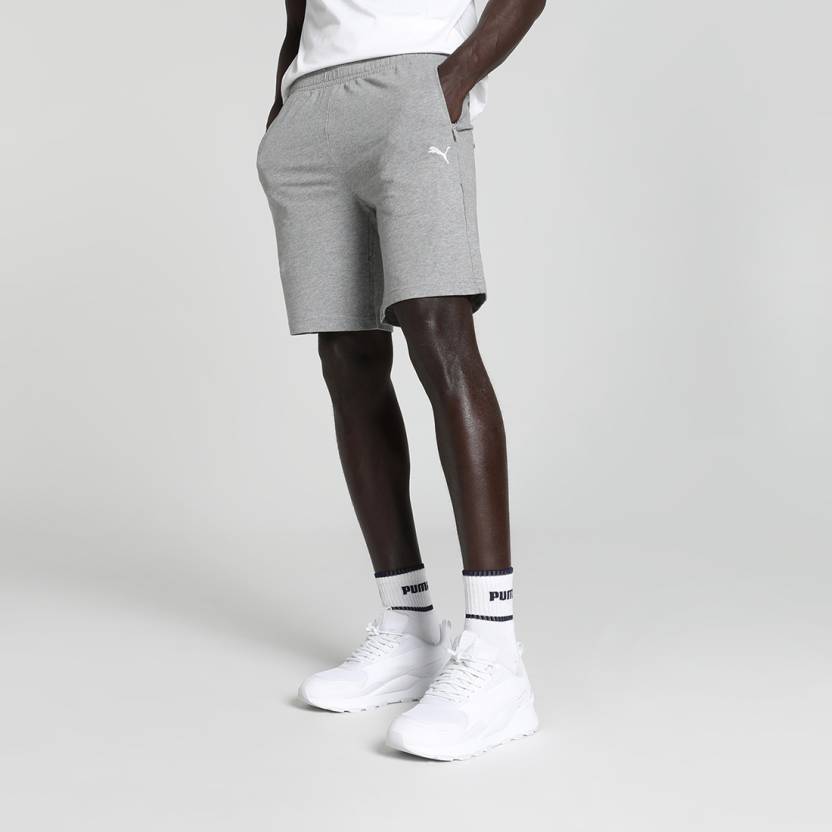 Side view of PUMA Men's Shorts, highlighting the relaxed fit, soft fabric, and signature PUMA logo for a comfortable and stylish casual look.