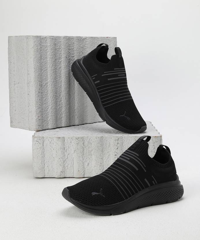 Side view of PUMA Men's Running Slip-On Sneakers, highlighting the breathable upper, cushioned midsole, durable outsole, and iconic PUMA logo, designed for comfort and performance in running and active wear.