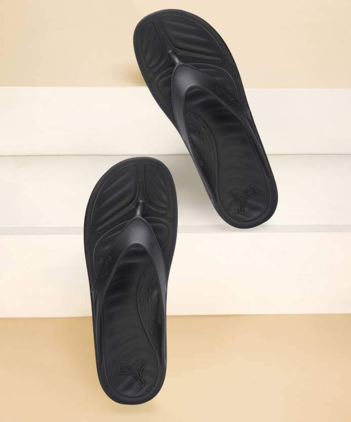 Side view of PUMA Men's Slippers, showcasing the soft plush interior, non-slip outsole, and iconic PUMA logo, designed for comfort and stability during indoor wear.