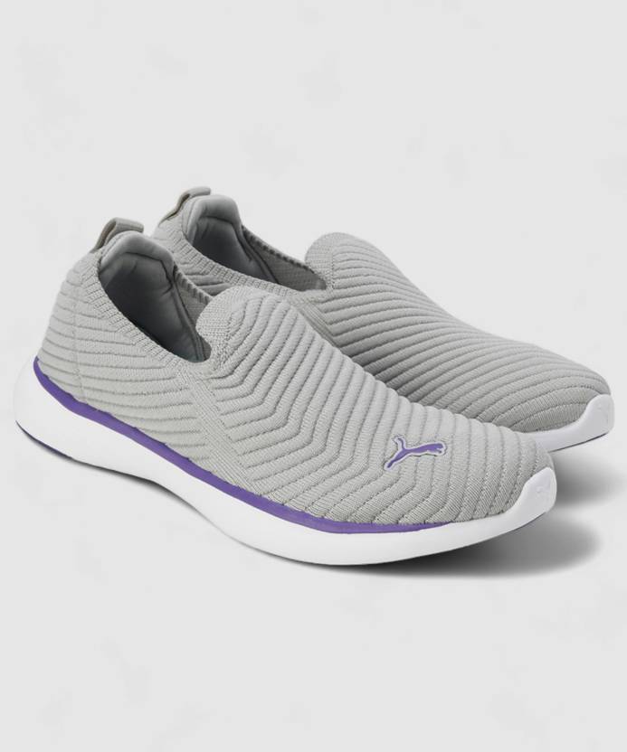 Side view of PUMA Women's Running Slip-On Sneakers, highlighting the breathable upper, cushioned midsole, durable outsole, and iconic PUMA logo, designed for comfort and performance in running and active wear.